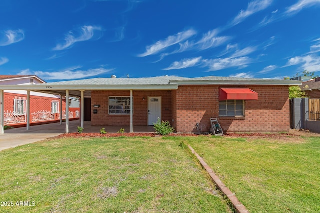 ranch-style house featuring brick siding, fence, a front lawn, and a carport