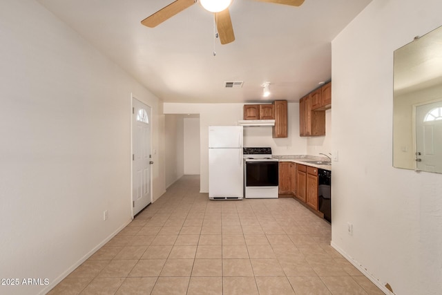 kitchen with a sink, freestanding refrigerator, a ceiling fan, under cabinet range hood, and range with electric stovetop