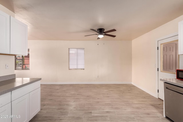 kitchen with ceiling fan, fridge, light wood-type flooring, and white cabinetry