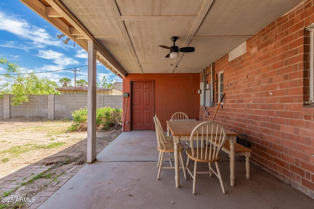 view of patio featuring fence, a ceiling fan, and outdoor dining area