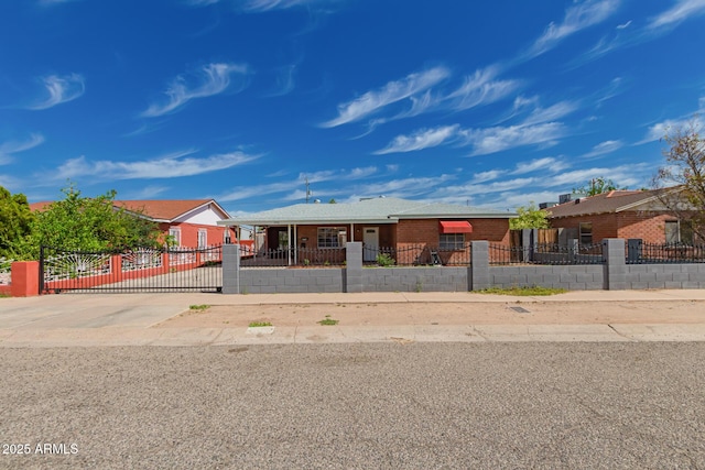 ranch-style home with a fenced front yard and brick siding