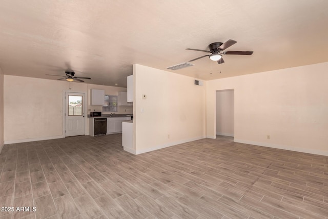 unfurnished living room featuring light wood-style floors, baseboards, a ceiling fan, and visible vents