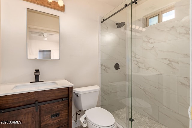 bathroom featuring vanity, toilet, and a stall shower