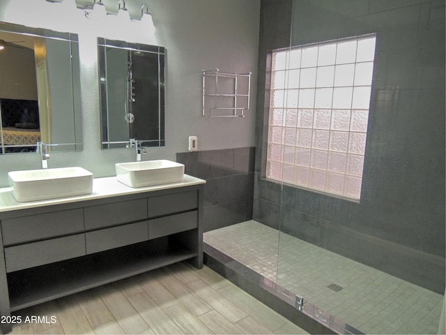 bathroom featuring vanity and a tile shower