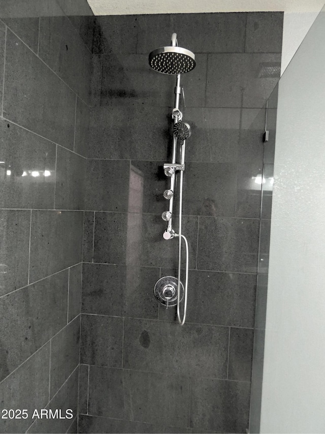 bathroom with tiled shower