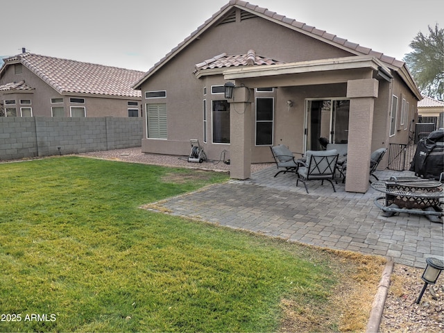 rear view of house with a yard and a patio