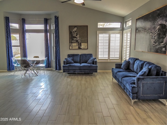 living room featuring hardwood / wood-style flooring, ceiling fan, and lofted ceiling