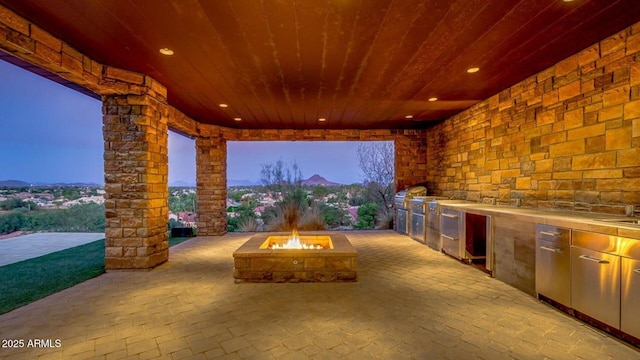 15217 N 15th Dr, Phoenix, AZ 85023 - view of patio / terrace featuring exterior kitchen and a fire pit