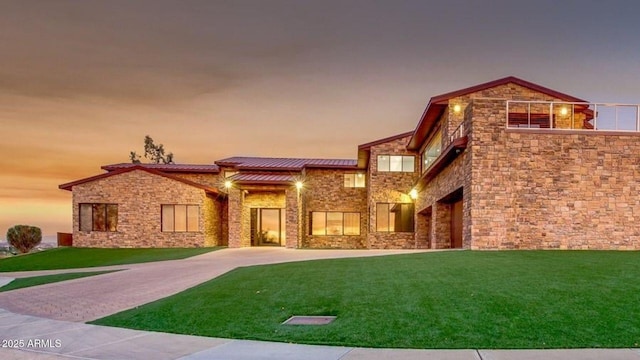 15217 N 15th Dr, Phoenix, AZ 85023 - view of front of home featuring stone siding, metal roof, a front yard, and a standing seam roof