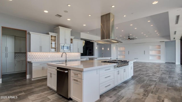 15217 N 15th Dr, Phoenix, AZ 85023 - kitchen featuring a sink, a large island with sink, ceiling fan, island range hood, and appliances with stainless steel finishes