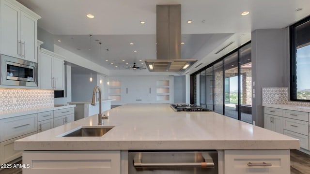 15217 N 15th Dr, Phoenix, AZ 85023 - kitchen with a sink, island exhaust hood, a large island with sink, backsplash, and appliances with stainless steel finishes