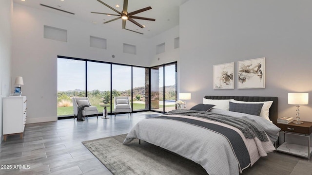 15217 N 15th Dr, Phoenix, AZ 85023 - bedroom with a high ceiling, baseboards, access to exterior, and multiple windows