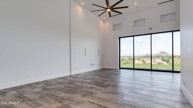 15217 N 15th Dr, Phoenix, AZ 85023 - unfurnished room featuring baseboards, recessed lighting, ceiling fan, and a towering ceiling