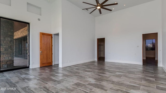 15217 N 15th Dr, Phoenix, AZ 85023 - unfurnished living room featuring baseboards, a towering ceiling, and ceiling fan