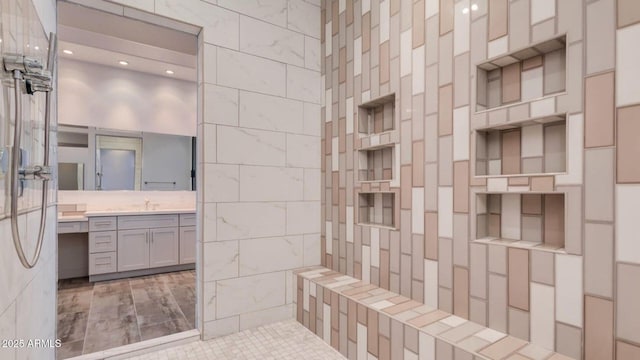 15217 N 15th Dr, Phoenix, AZ 85023 - bathroom featuring a tile shower, tile walls, and vanity