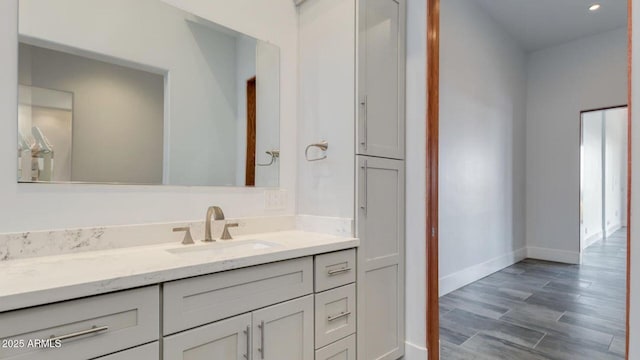 15217 N 15th Dr, Phoenix, AZ 85023 - bathroom featuring baseboards, vanity, recessed lighting, and wood finished floors