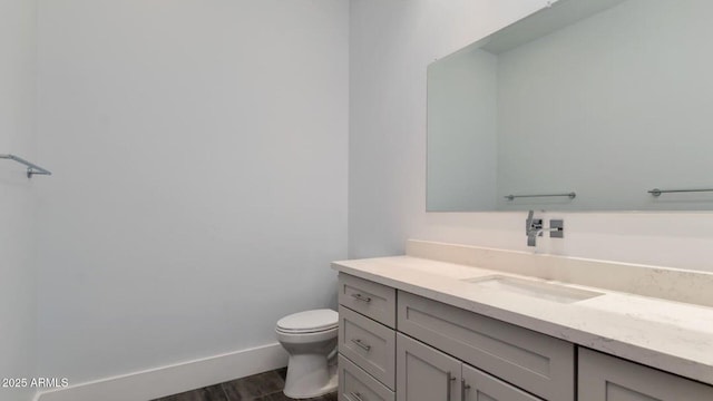 15217 N 15th Dr, Phoenix, AZ 85023 - bathroom with toilet, baseboards, vanity, and wood finished floors