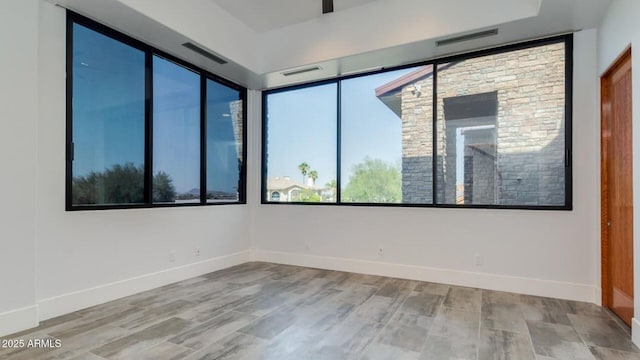 15217 N 15th Dr, Phoenix, AZ 85023 - empty room with baseboards, visible vents, and wood finished floors