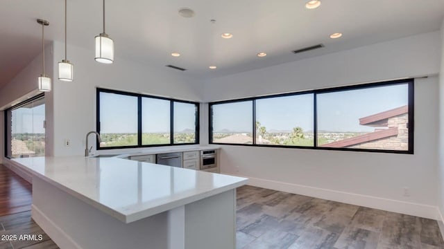 15217 N 15th Dr, Phoenix, AZ 85023 - kitchen with a sink, a peninsula, stainless steel oven, visible vents, and dishwasher