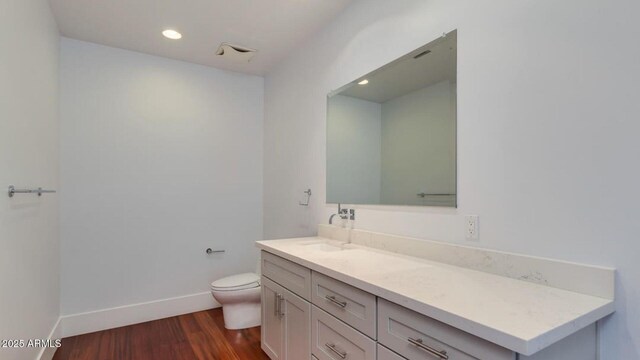 15217 N 15th Dr, Phoenix, AZ 85023 - bathroom with toilet, wood finished floors, vanity, recessed lighting, and baseboards