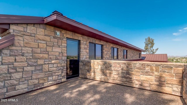 15217 N 15th Dr, Phoenix, AZ 85023 - view of side of home with metal roof, a standing seam roof, and stone siding