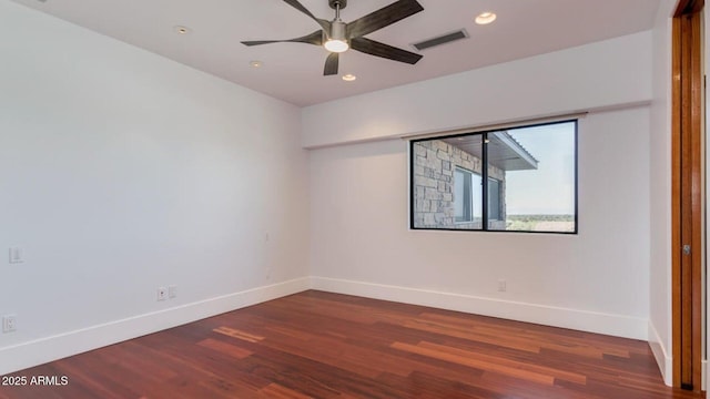 15217 N 15th Dr, Phoenix, AZ 85023 - empty room with baseboards, visible vents, and dark wood-type flooring