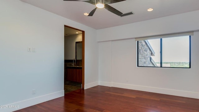 15217 N 15th Dr, Phoenix, AZ 85023 - empty room with recessed lighting, baseboards, ceiling fan, a sink, and wood finished floors