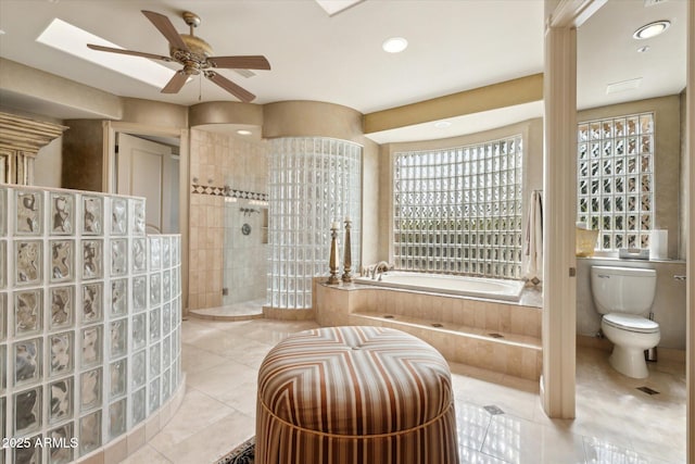 full bath featuring toilet, a ceiling fan, a bath, a walk in shower, and tile patterned floors