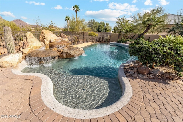 view of swimming pool featuring a fenced in pool, fence, and a mountain view