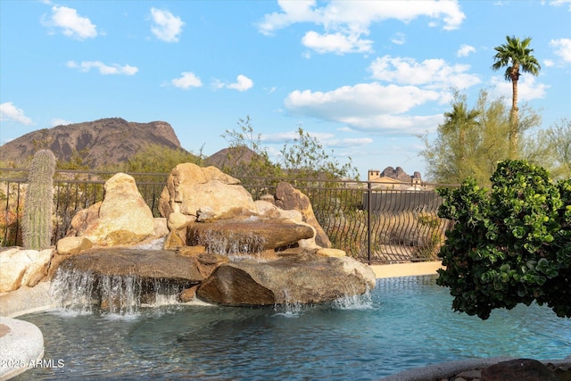 exterior space featuring fence and a mountain view