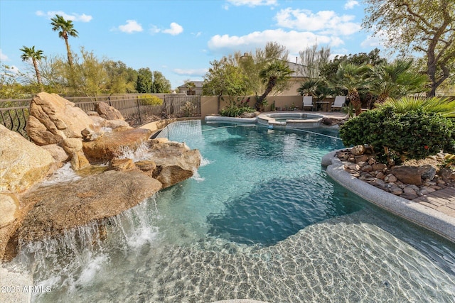 view of pool with a pool with connected hot tub and fence