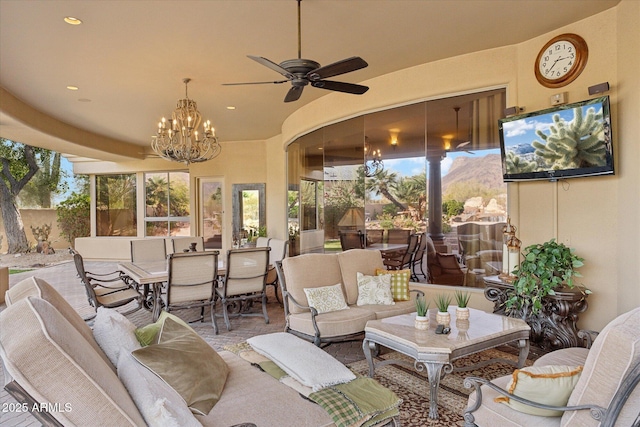 sunroom / solarium with ceiling fan with notable chandelier