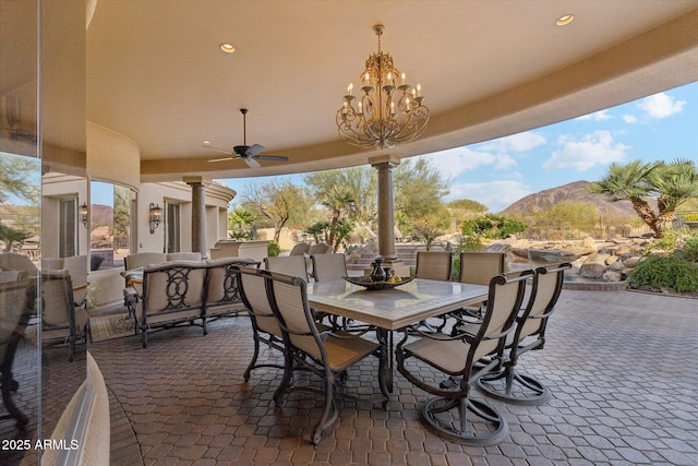 view of patio / terrace with a mountain view, outdoor dining area, a ceiling fan, and an outdoor living space