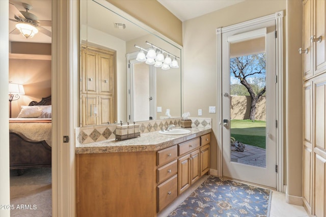 bathroom with visible vents, ceiling fan, connected bathroom, and vanity