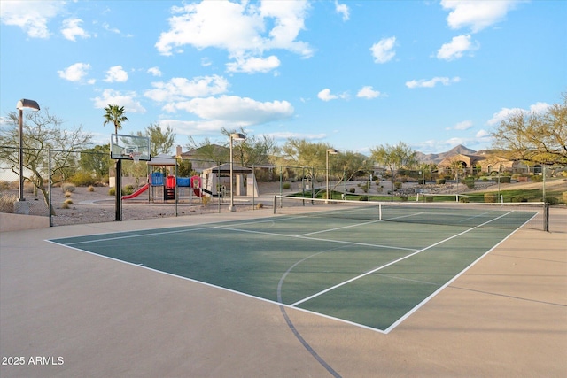 view of sport court with fence and playground community