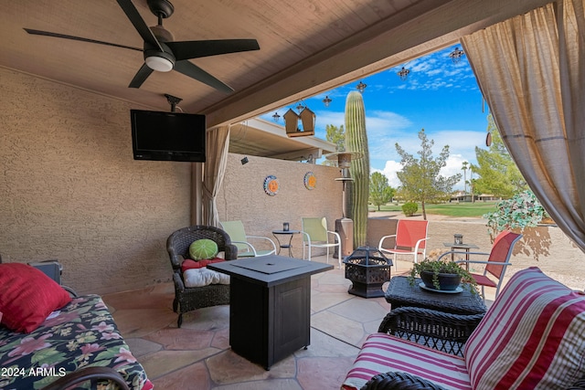 view of patio / terrace featuring ceiling fan and a fire pit