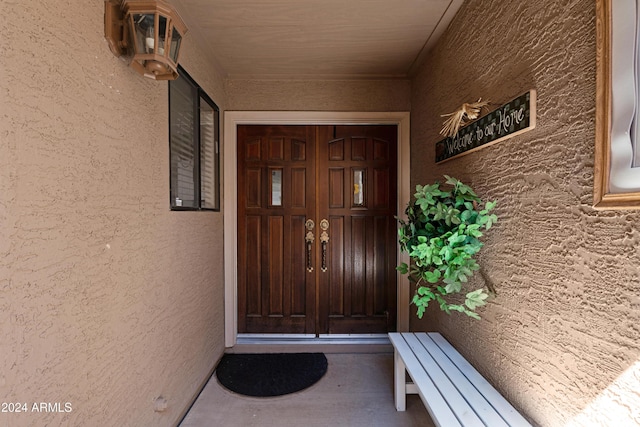 property entrance with stucco siding