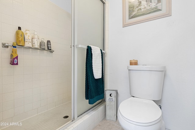 full bath with tile patterned floors, toilet, and a stall shower