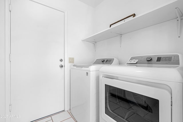 clothes washing area with laundry area, light tile patterned floors, and independent washer and dryer