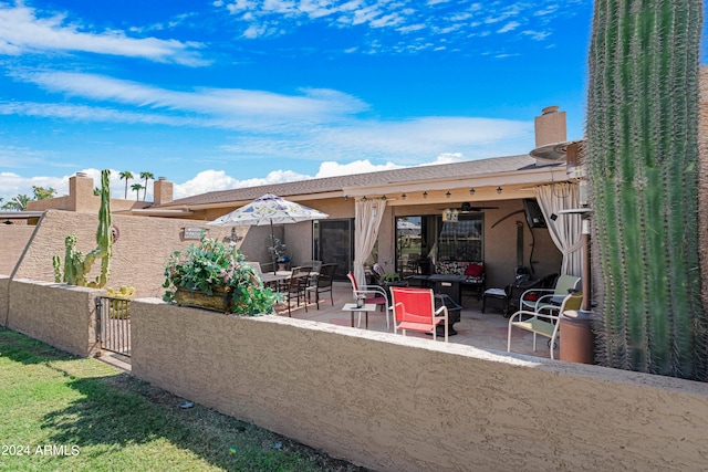 rear view of house with a patio, fence, ceiling fan, a chimney, and an outdoor hangout area