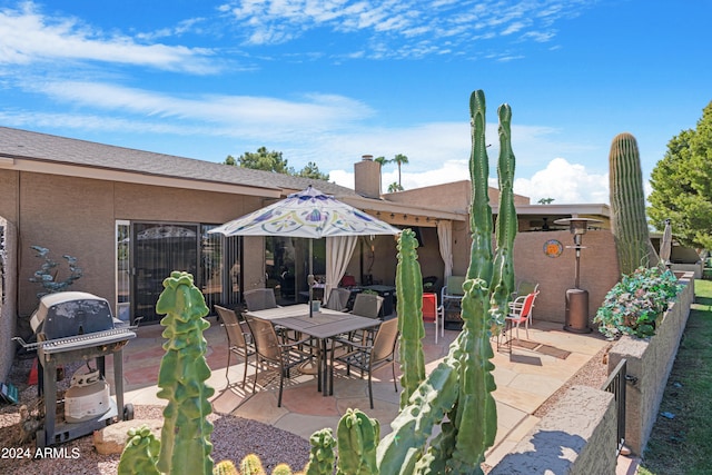 view of patio with outdoor dining space and grilling area