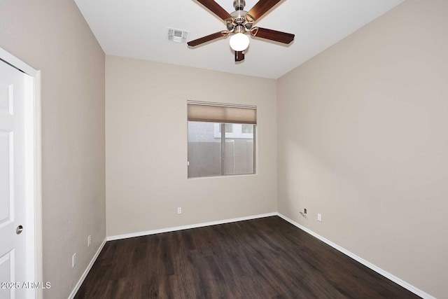 empty room with visible vents, ceiling fan, baseboards, and wood finished floors