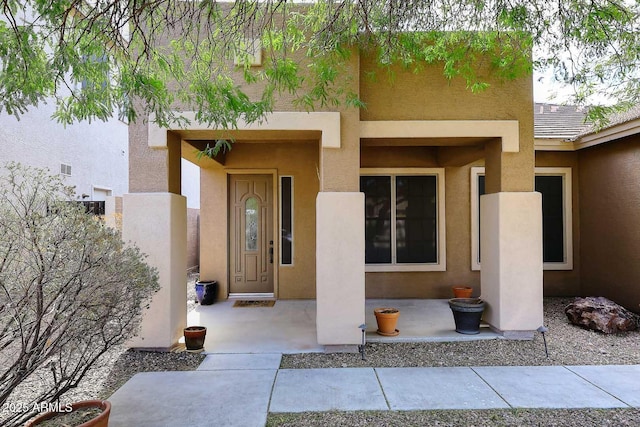 entrance to property with stucco siding