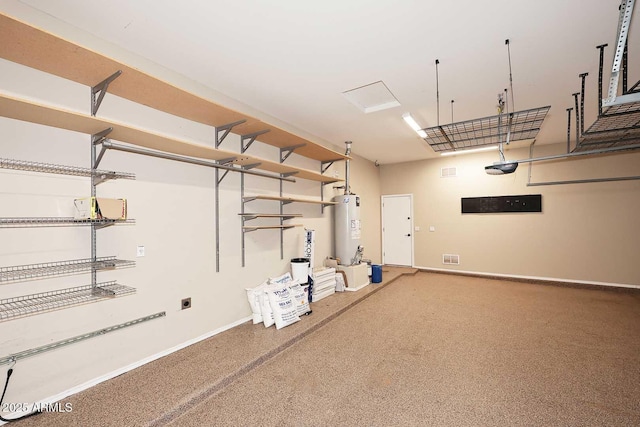 garage featuring water heater, baseboards, and a garage door opener