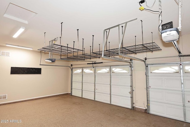 garage with a garage door opener and baseboards