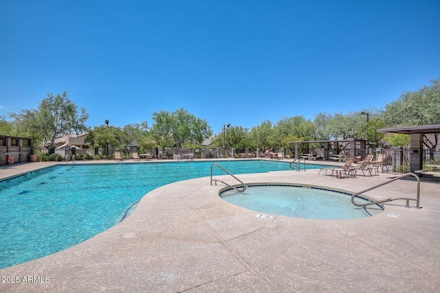 community pool featuring fence and a patio