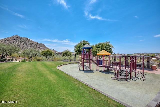 communal playground with a lawn and a mountain view