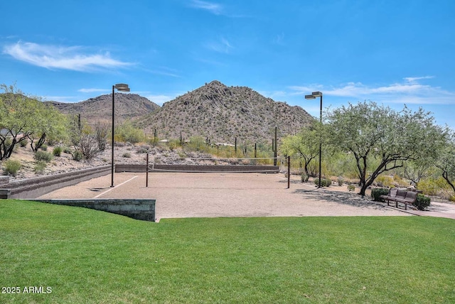 view of home's community featuring a yard, a mountain view, and volleyball court