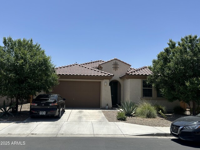 25931 W Deer Valley Rd, Buckeye, AZ 85396 - view of front of home with a garage, stucco siding, concrete driveway, and a tile roof