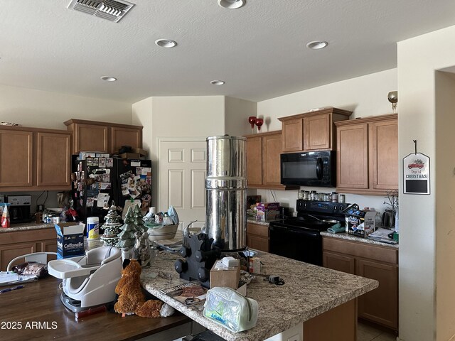 25931 W Deer Valley Rd, Buckeye, AZ 85396 - kitchen featuring black appliances, brown cabinetry, wood finished floors, recessed lighting, and a kitchen breakfast bar